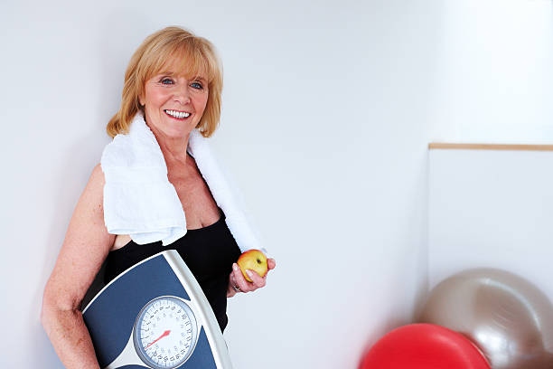 Senior Woman Holding Scale