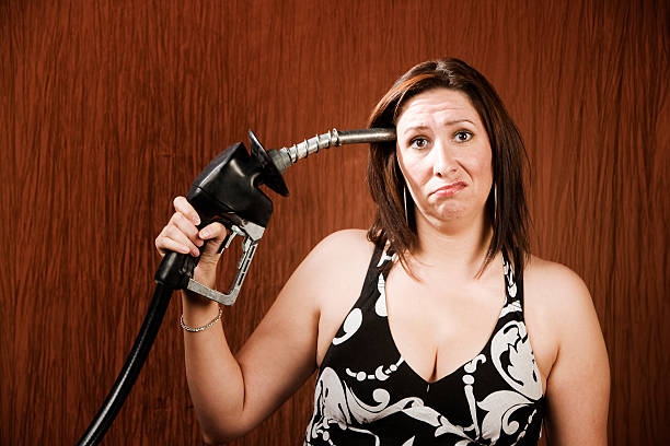 Woman Holding Gas Nozzle To Her