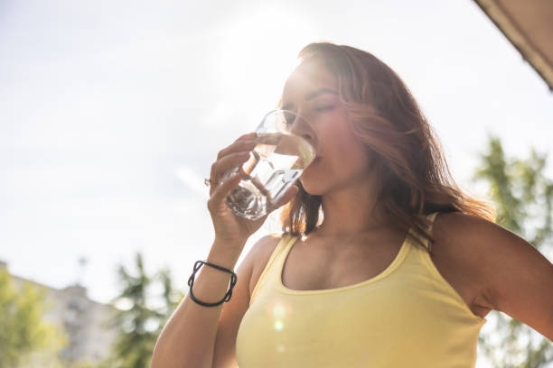 Thirsty Sportswoman Drinks Water
