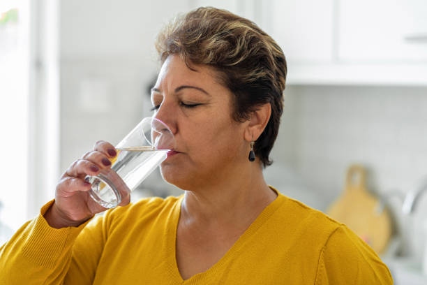 Woman Drinking From A Glass Of W